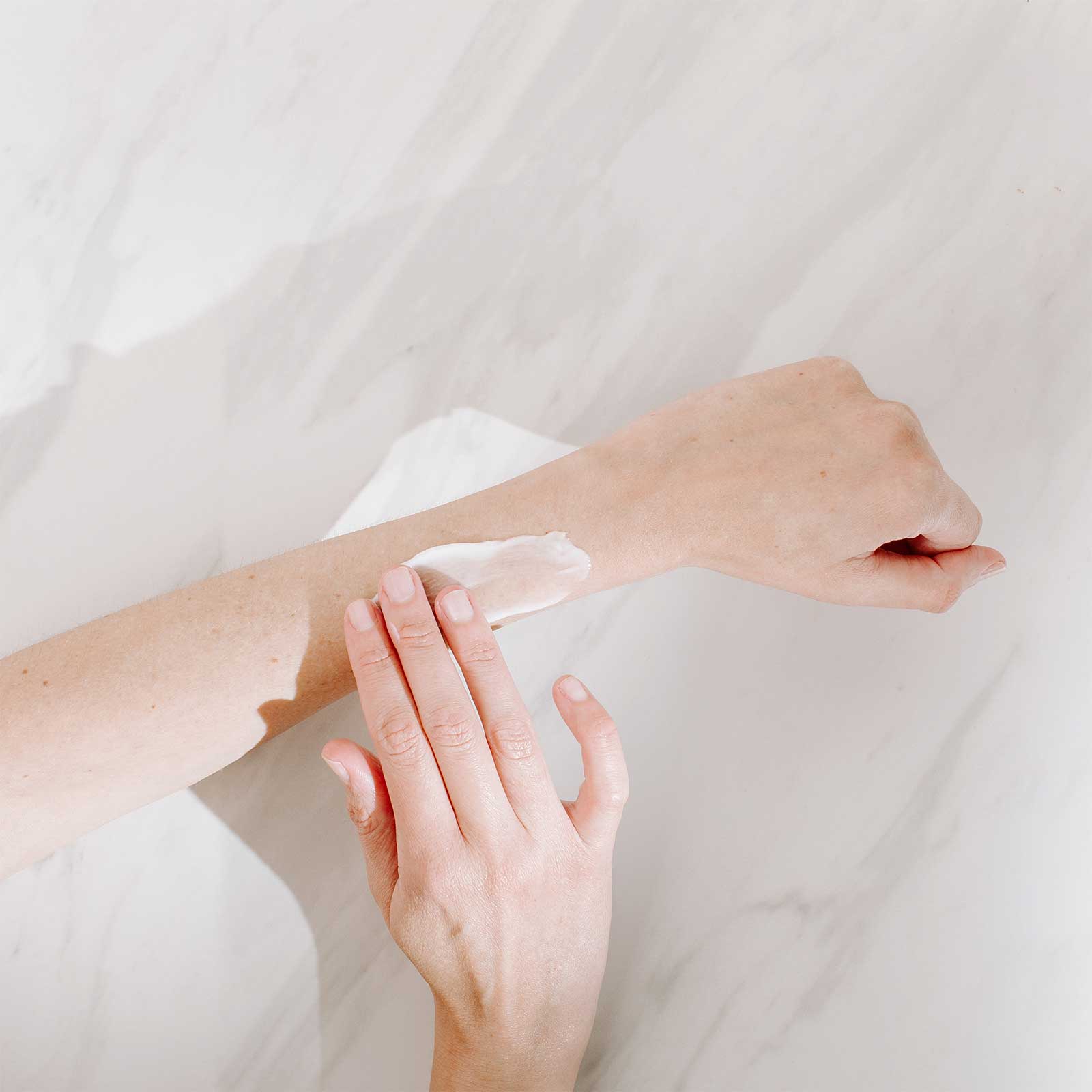 A Girl Applying Cream on her Hand