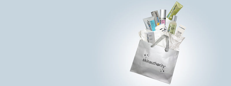 Skincare products in a clear bag with Skin Authority  branding on a light blue background
