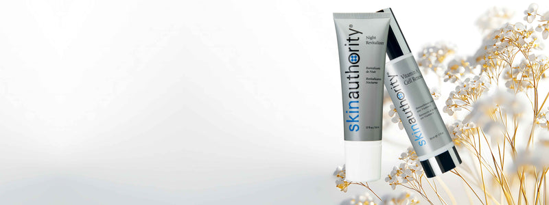 Two skincare bottles with a light background and decorative elements