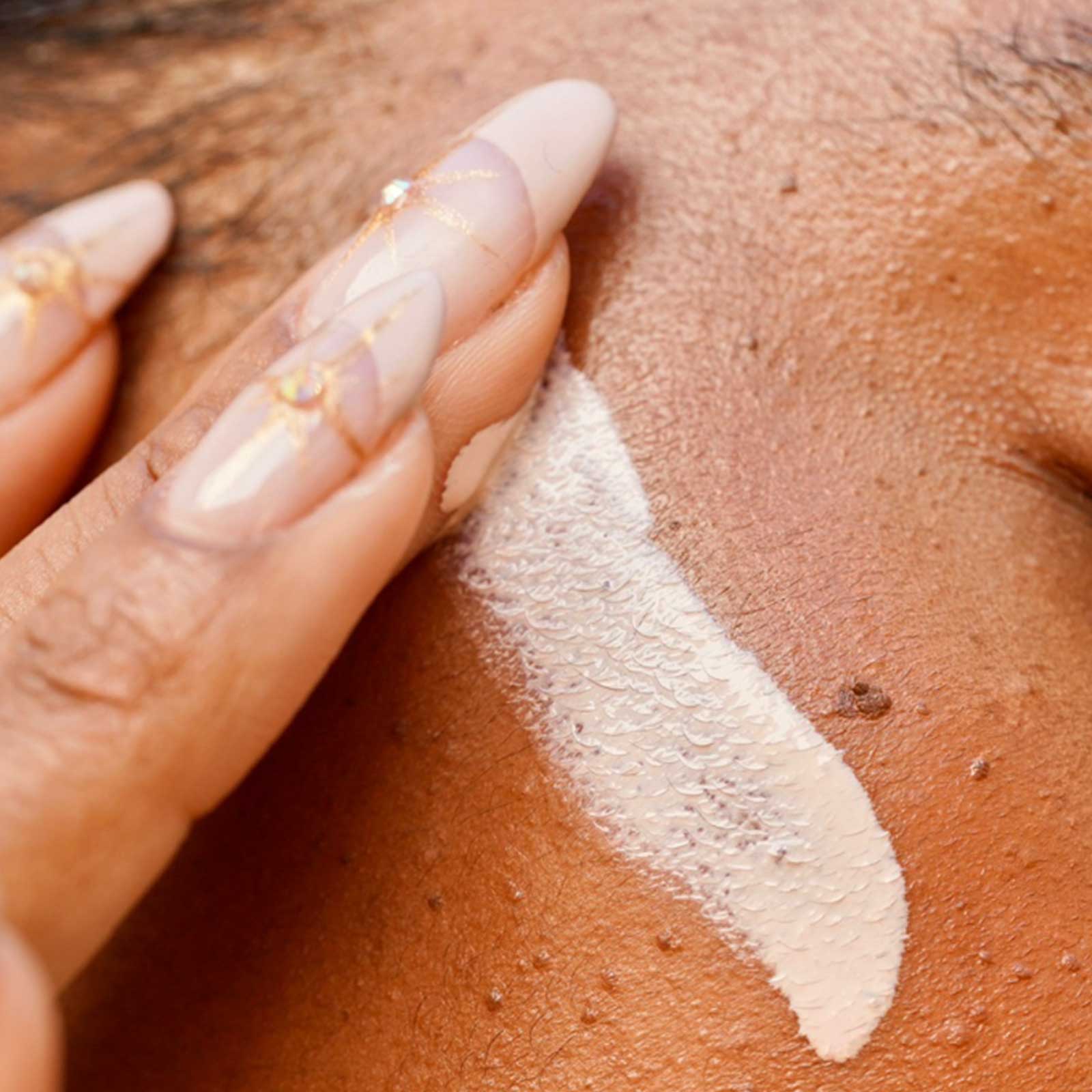 A Girl Applying Cream on her Face